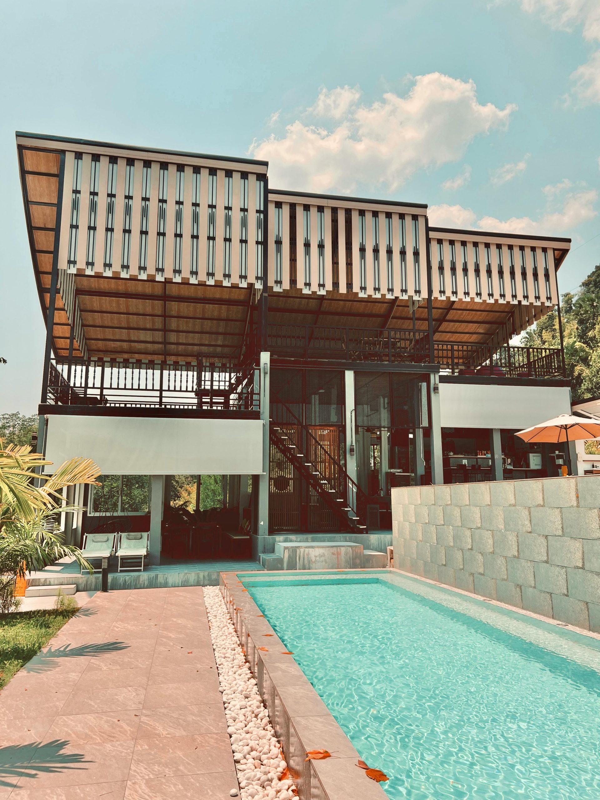 Stunning modern villa with a pool and lush surroundings in a tropical setting.